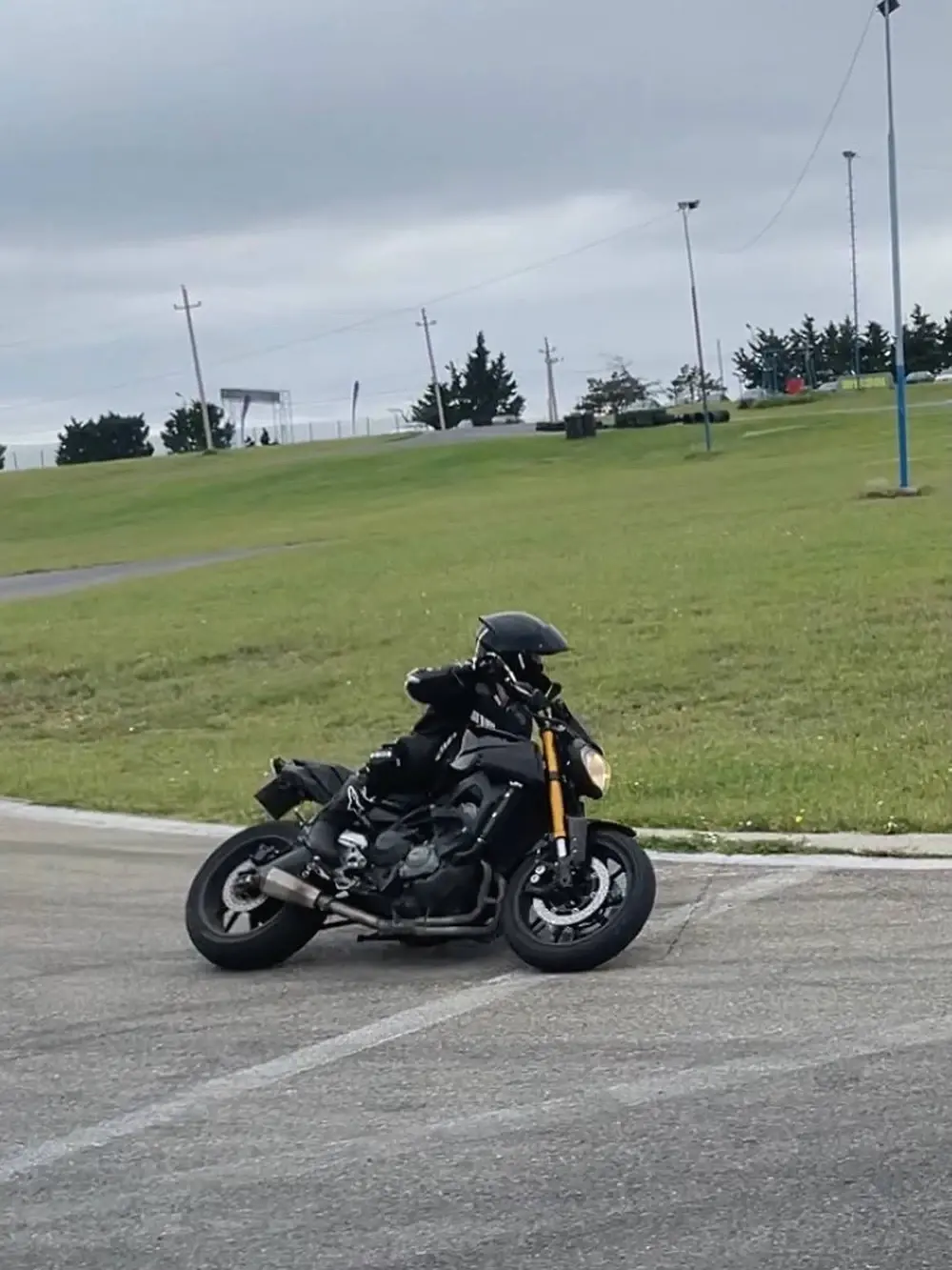 Nikita riding a motorcycle through a bend on a track
